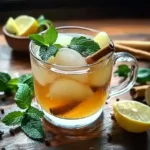 Refreshing detox drink representing Ice Spice Weight Loss routine, featuring a glass of iced tea with lemon slices, mint leaves, and cinnamon sticks to promote natural fat burning and stress balance.