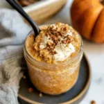 Creamy pumpkin overnight oats in a glass jar topped with yogurt and crunchy granola — an easy, healthy fall breakfast recipe.