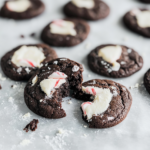 Close-up of chewy chocolate peppermint cookies with melted white peppermint pieces on top.