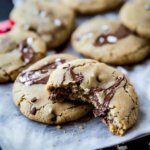 Soft Nutella cookies with a gooey melted center and a bite taken out.